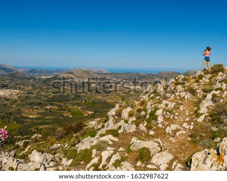 Tourist woman take travel picture from mountains landscape in Spain. Coll de Rates cycling route, view on the way up. Costa Blanca holiday