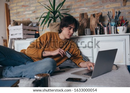 young man online shopping from his home