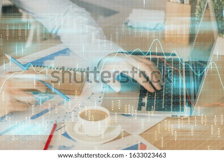 Forex graph with businessman working on computer in office on background. Concept of hardworking. Multi exposure.