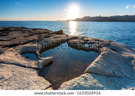 Rocky coastline of Malta and Mediterranean Sea at sunrise