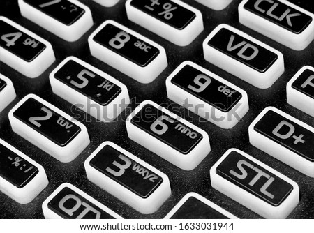 the buttons of a calculator on a black background