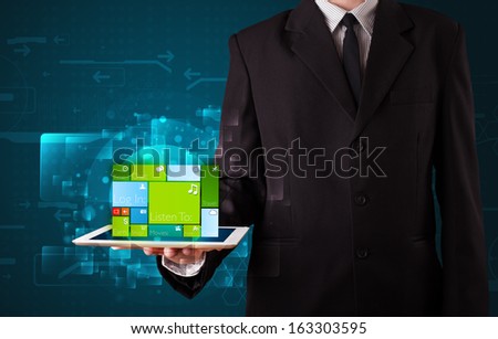 Young businessman holding a tablet with modern software operational system
