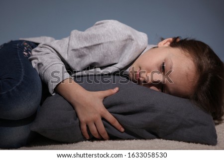 Lonely sad girl at home. The concept of loneliness. saddened alarmed child alone at home.
 Royalty-Free Stock Photo #1633058530
