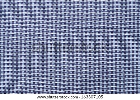 Texture of fabric in a cage for an abstract background and a surface, a closeup