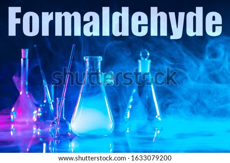 The inscription formaldehyde and chemical glass ware. Use of formaldehyde in the production of resins. Production of resins for chipboard and plywood. Carcinogens, toxic substances. Types of gases. Royalty-Free Stock Photo #1633079200