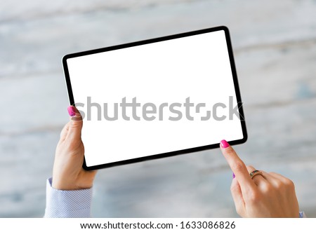 Woman holding tablet with empty white screen Royalty-Free Stock Photo #1633086826