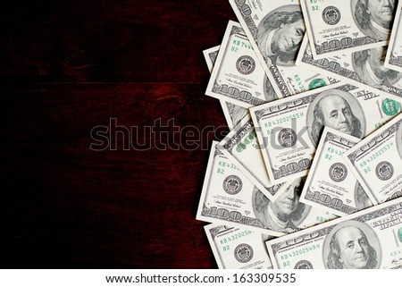 Background with money american hundred dollar bills on wooden desk