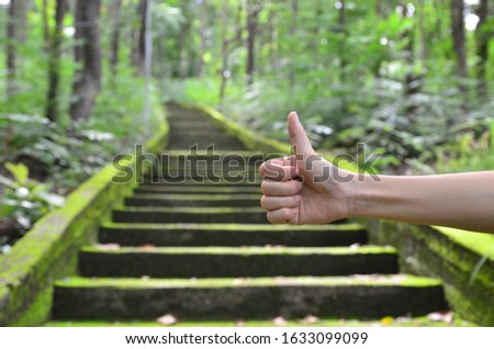 Green  staircase to  success with hand
