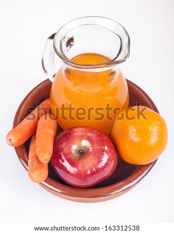 apple, orange and carrots with fresh juice in the background