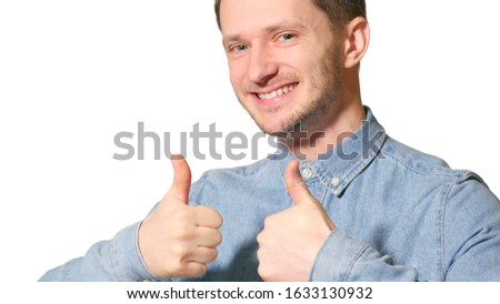 Young handsome man over isolated background happy with big smile doing ok sign, thumb up with fingers, like