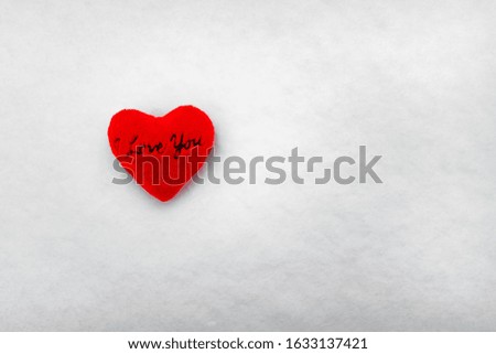 
heart with the text "I love you" in the snow