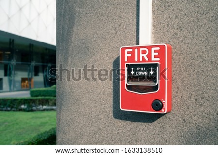 fire alarm system on wall at open air shopping plaza, shallow depth of field