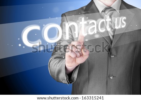 Businessman pushing CONTACT US sign