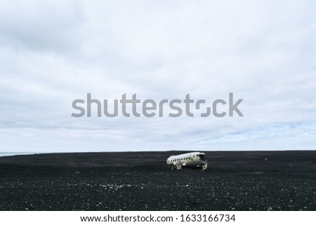 Wrecked plane on the black sand beach in Iceland. Atmospheric Icelandic landscape