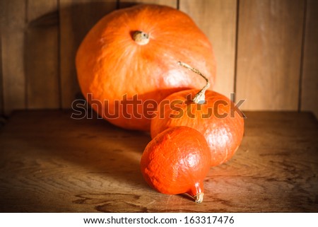 Pumpkins on grunge wooden backdrop, background table. Autumn, halloween, pumpkin