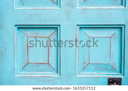 Close up background detail of vintage and rustic blue cyan wood door, with space for text