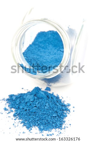 Blue pigment in a glass jar on a white background