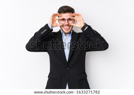 Young caucasian business man posing in a white background isolated Young caucasian business man showing okay sign over eyes