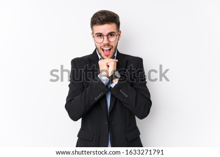 Young caucasian business man posing in a white background isolated Young caucasian business man praying for luck, amazed and opening mouth looking to front.