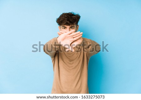 Young arabian man isolated doing a denial gesture