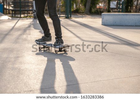 Unrecognizable skateboarder on his board. Photo was taken in backlight