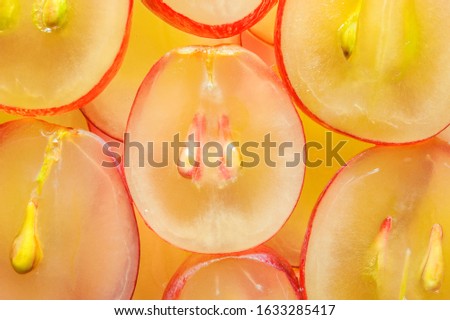 juicy yellow red grapes cut into pieces with pits inside Royalty-Free Stock Photo #1633285417