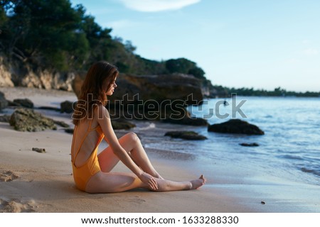 young woman with a beautiful figure in a swimsuit on vacation