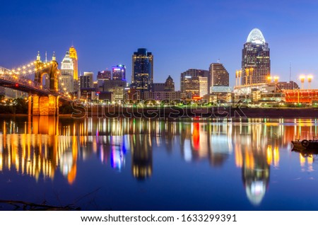 Cincinnati skyline at dawn with reflections from the building in the River Ohio