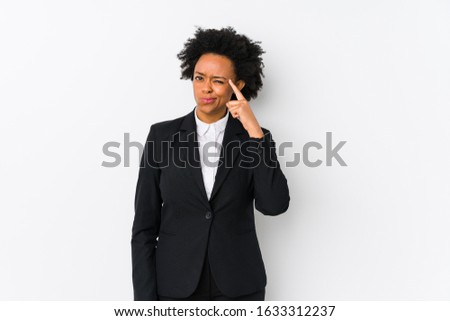 Middle aged african american business  woman against a white background isolated showing a disappointment gesture with forefinger.