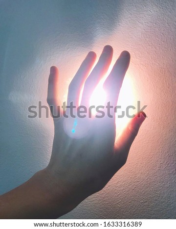 female hand reaches for the light. hope faith love. religion. praying