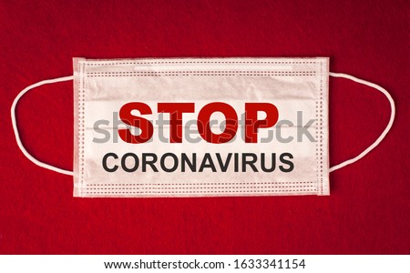 Medecin mask on a red background with the inscription" stop koronavirus" Royalty-Free Stock Photo #1633341154