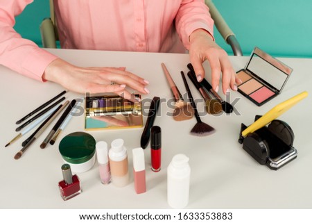 Beauty blogger producing makeup tutorial online translation - image