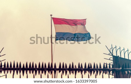 Netherlands Border, Netherlands Flag next to Embassy Fence, toned Picture