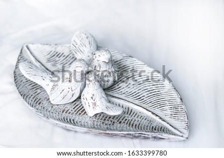 Family of wooden easter birds on a white vintage tray. partial blur, white background. family and love concept.