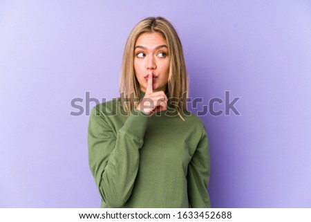 Young blonde caucasian woman isolated keeping a secret or asking for silence.