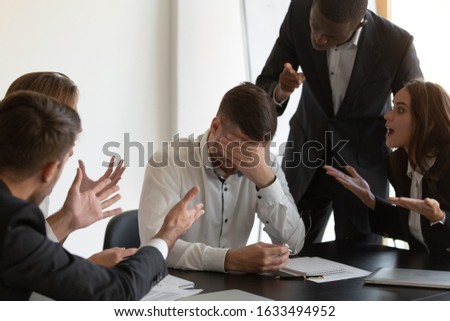 Frustrated employee cover face with hand feels unhappy having serious problems suffers from hostile co-workers, feels guilty, unfair attitude, harassment, stress, discrimination at workplace concept Royalty-Free Stock Photo #1633494952