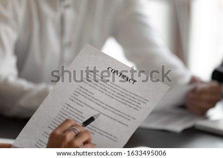 Parties discuss contract details close up view man holding pen reading terms and conditions legal obligations, credit in bank, purchase and sale, hiring and rental agreement between entities concept Royalty-Free Stock Photo #1633495006