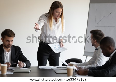 At group meeting businesspeople gathered in boardroom witnessed a conflict between female boss and employee, accusing for mistake, disagreement with team member, bad work, rivalry at workplace concept Royalty-Free Stock Photo #1633495189