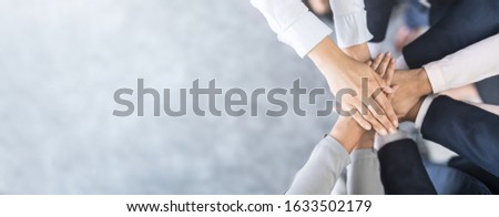 Close up top view of young business people putting their hands together. Stack of hands. Unity and teamwork concept. Royalty-Free Stock Photo #1633502179