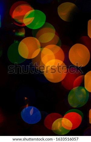 Bokeh of colored round festive Christmas lights.