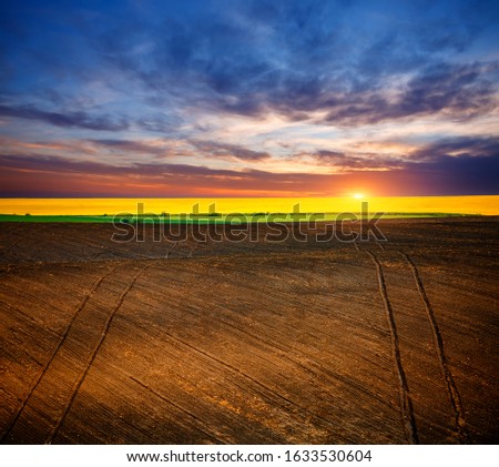 Picturesque rural area and plowed field on the springtime. Location place of Ukrainian agrarian region, Europe. Photo of ecology concept. Agrarian industry. Perfect wallpapers. Beauty of earth.