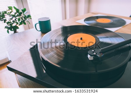 Turntable with gramophone record playing music. Gramophone, vinyl, long play record Royalty-Free Stock Photo #1633531924