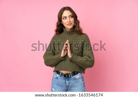 Young woman over isolated pink background scheming something