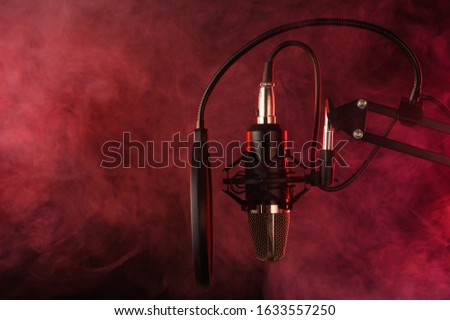 Disco music, karaoke, sign. Studio microphone on a background of colored red smoke. Banner, poster