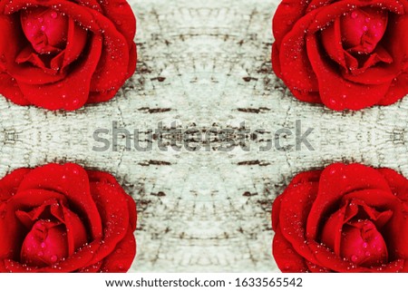 Background with four red roses on wooden background