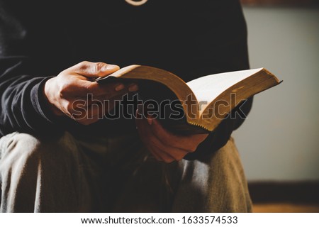 Sunday readings bible, a christian man reading the bible.