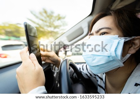 Asian woman wearing medical face mask of many layers,worried people check information or search for news from the phone about epidemic,spread of germ,Coronavirus,Covid-19,Wuhan coronavirus 2019-nCoV