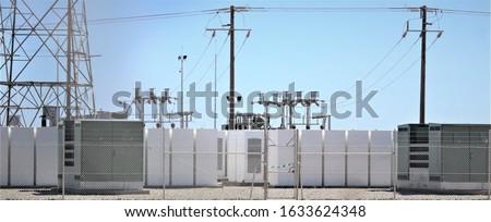 Battery storage at a Solar Farm with switchgear or switch gear in the background Royalty-Free Stock Photo #1633624348