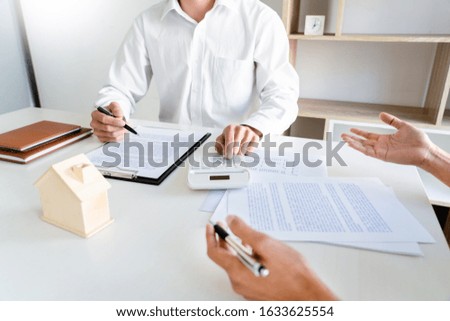 Real Estate Agent broker or House developer showing contract for buying house agreement to consultant employee