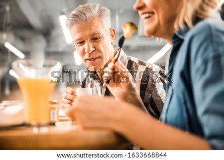 Happy adult man and woman spending time in cafe stock photo